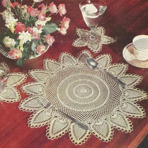 May include: A white ceramic mug with a black handle and the text "But First, Coffee" in a handwritten style. The mug is on a white surface. The mug is approximately 4 inches tall.