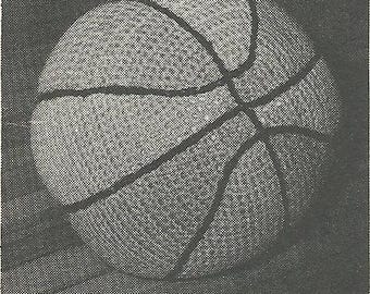 May include: A crocheted basketball in black and white, with the classic panel design. The ball is textured and appears to be handmade. The text "CROCHETED BASKETBALL" is at the bottom of the image.