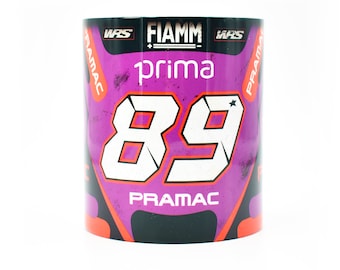 May include: A purple and black ceramic mug with a racing design. The mug features the number 89, the words "Pramac", "Fiamm", and "Prima", and a star.
