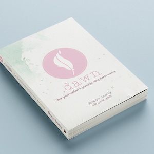 May include: A white book with a pink circle on the cover. The circle contains a white feather design. The book title is "dawn" and the text reads "Your guided workbook & journal for finding inner harmony". The author is Eleanor Loseby with special guests.