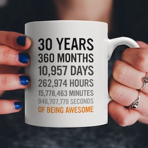 May include: White ceramic mug with black text that reads "30 Years 360 Months 10,957 Days 262,974 Hours 15,778,463 Minutes 946,707,779 Seconds of Being Awesome".