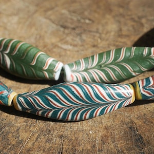 May include: A white ceramic mug with a black handle and the text "But First, Coffee" in a black, bold font. The mug is likely 325 ml in size and sits on a white surface.