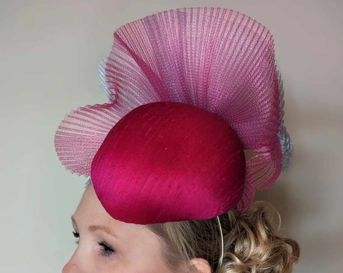 Statement cerise pink silk teardrop hat. Decorated with pleated crin swirls. Perfect for Mother of the bride, Ascot, races