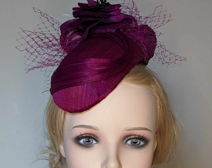 Magenta, abaca silk hat. Decorated with handmade flowers,bows and veiling. Perfect for Mother of the bride, Ascot or ladies day races