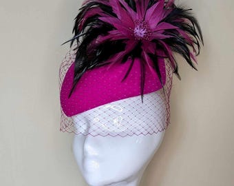 Beautiful cerise/fuchsia pink wool felt hat, decorated with feathers.  Finished with birdcage veiling. Perfect for Cheltenham festival.