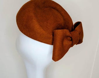 Rust pure wool Jackie Kennedy Pillbox Hat: Handblocked with bow detail.