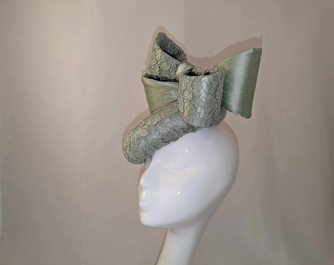 Pale green silk and lace statement button hat, decorated with oversized bows, great races and creating the wow factor.