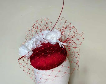 Beautiful silk button hat in shades of mauve and lilac. This stunning hat would look great for Ascot, ladies day races or mother of bride