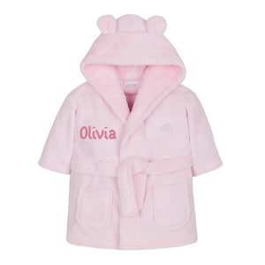 May include: Pink hooded bathrobe with bear ears and a personalized embroidered name "Olivia" on the front.