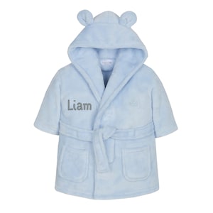 May include: Light blue hooded robe with bear ears, a tie belt, and two pockets. The robe is personalized with the name "Liam" embroidered on the front.