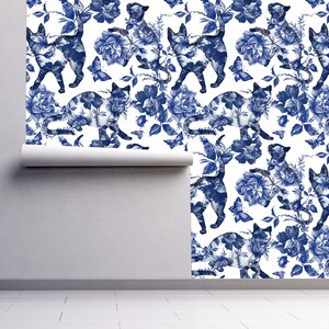 Blue cat and flower toile fabric peel and stick wallpaper on wall partially rolled up