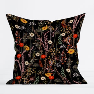 May include: Black pillow with a floral pattern featuring red, yellow, and pink flowers on a black background.