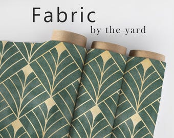 May include: Rolls of fabric with a geometric pattern of green and gold leaves. The fabric is labelled "Fabric by the yard".