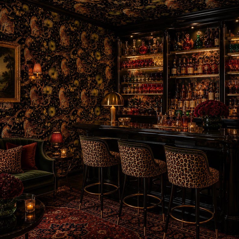 May include: A bar area featuring three high-backed bar stools with leopard print upholstery and black legs. The stools are positioned in front of a dark wooden bar counter with illuminated glass shelving displaying various bottles and glassware.