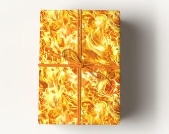 May include: A rectangular gift box wrapped in paper with a fiery flame pattern. The box is tied with orange twine, forming a bow. The flames are a mix of yellow, orange, and red, creating a vibrant and energetic design.