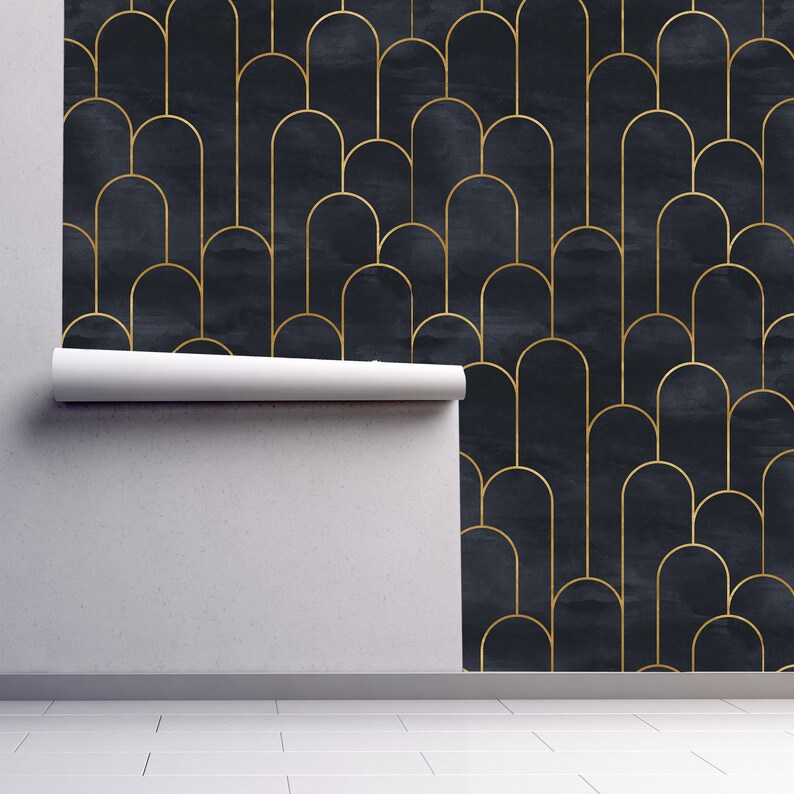 Moody dark Art Deco black and gold fabric peel and stick wallpaper on wall partially rolled up