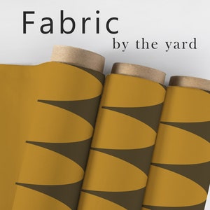 May include: Three rolls of fabric with a geometric pattern of brown and mustard yellow. The fabric is labeled "Fabric by the yard".