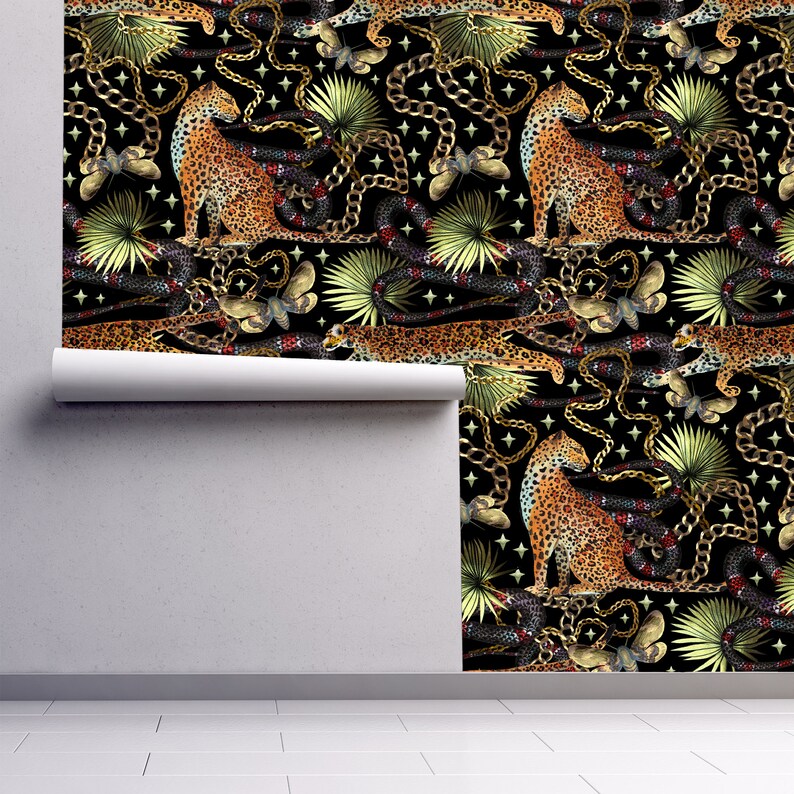 Black tropical cheetah print fabric peel and stick wallpaper on wall partially rolled up