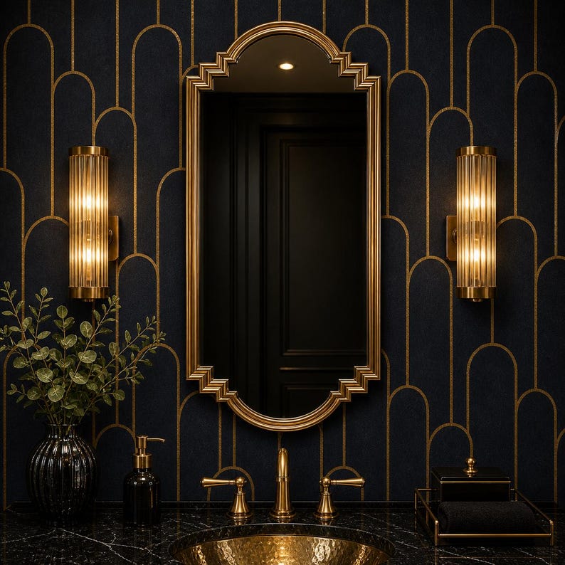 May include: A luxurious bathroom scene featuring a gold-framed mirror, gold fixtures, and sconces. The dark blue walls have a gold art deco pattern. A black marble countertop holds a gold sink, soap dispenser, and a black tray with a towel.