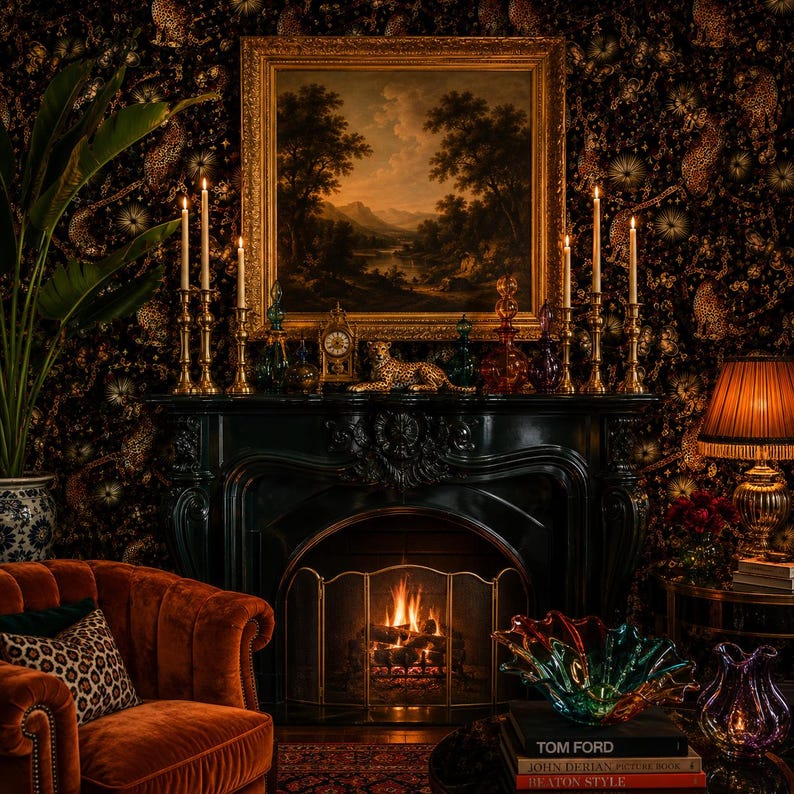 May include: A black fireplace mantel with a lit fire, topped with a gold-framed landscape painting, brass candlesticks, a leopard figurine, and a clock. A velvet armchair, a glass bowl, and books titled Tom Ford and John Derian are nearby.
