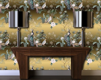May include: Two silver table lamps with black lampshades sit on a dark wood console table against a gold background wallpaper with a peacock and floral pattern.