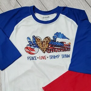 PEACE LOVE TRUMP Train, Printed Raglan Sleeve Tee, Bright Print, Red White & Blue, Leopard