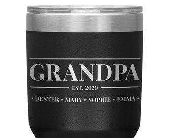 May include: Black stainless steel tumbler with a white inscription that reads "Grandpa Est. 2020 Dexter Mary Sophie Emma".