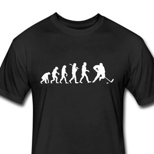 May include: Black t-shirt with a white silhouette of the evolution of man, ending with a hockey player holding a stick.