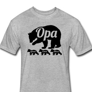 May include: A gray t-shirt with a black silhouette of a bear with the word " Opa" inside the bear.  Below the bear are three smaller bears with the names "Ieland", "Cedric", and "Atticus" written underneath.