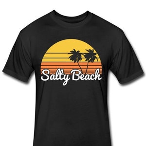 May include: Black t-shirt with a retro sunset graphic and palm trees. The text "Salty Beach" is printed in white below the graphic.