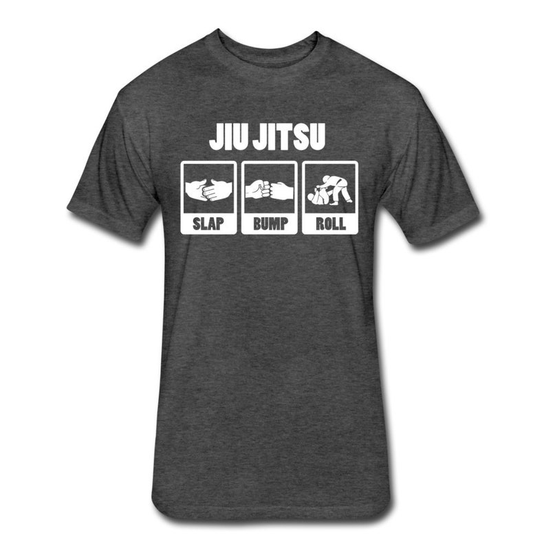 May include: A dark heather grey t-shirt with a white graphic that says "Jiu Jitsu" and shows three steps: "Slap", "Bump", and "Roll".