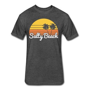 May include: Dark heather grey t-shirt with a retro sunset graphic featuring palm trees and the text "Salty Beach".