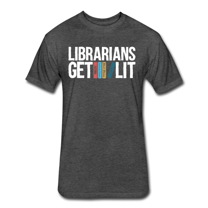 May include: Dark heather grey t-shirt with white text that reads "Librarians Get Lit" and a graphic of four colorful books.