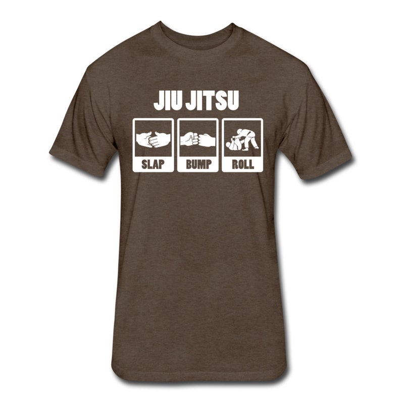 May include: A brown t-shirt with the text "JIU JITSU" in white letters. Below the text are three white boxes with illustrations of hands slapping, bumping, and rolling, with the words "SLAP", "BUMP", and "ROLL" underneath each illustration.