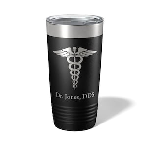 May include: Black stainless steel tumbler with a silver medical symbol and the text "Dr. Jones, DDS".
