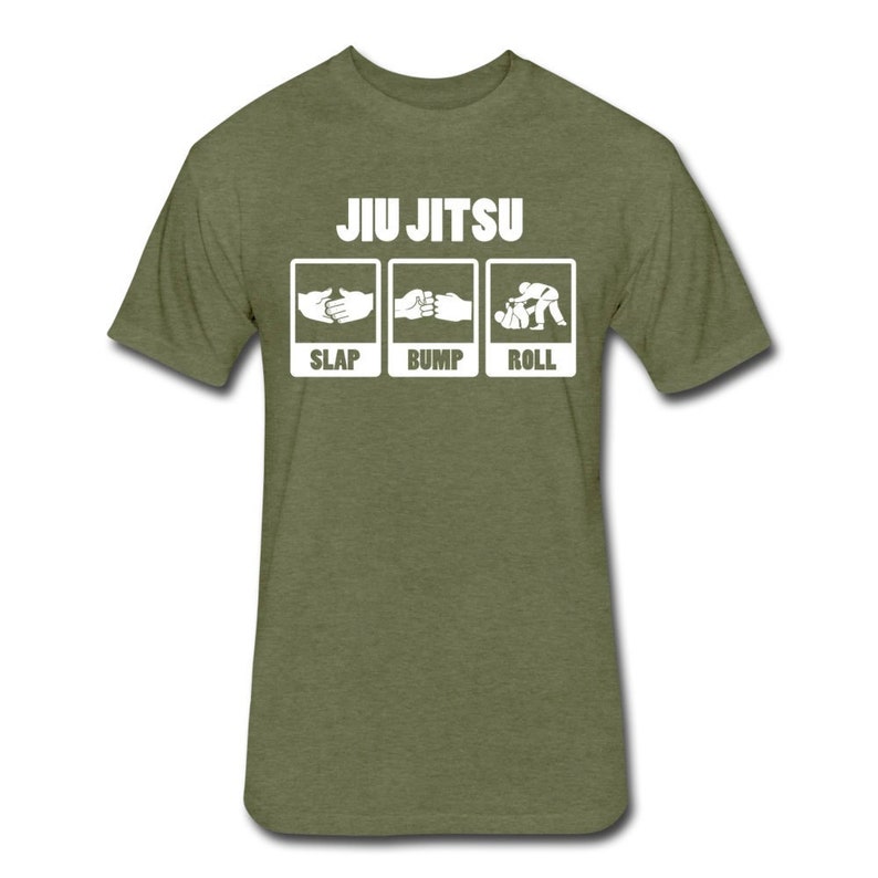 May include: A green t-shirt with the text "JIU JITSU" in white. Below the text are three white squares with illustrations of hands slapping, bumping, and rolling. The text below the illustrations reads "SLAP", "BUMP", and "ROLL".