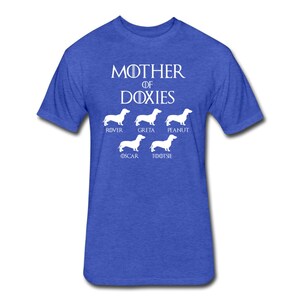 May include: A royal blue t-shirt with the text "Mother of Doxies" in white. Below the text are five white silhouettes of Dachshunds with the names "Rover", "Greta", "Peanut", "Oscar", and "Tootsie" underneath.