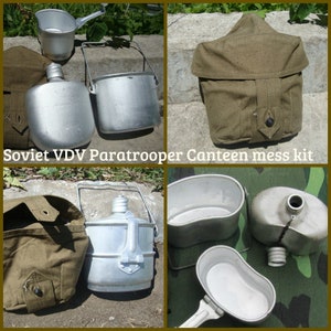 May include: A Soviet VDV paratrooper canteen mess kit consisting of a silver aluminum canteen, a nesting cup with a folding handle, and a khaki canvas carrying pouch with a button closure. The set is shown in various configurations and angles.