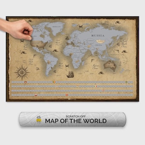 Könnte beinhalten: Eine Rubbelweltkarte im Vintage-Stil. Die Karte zeigt eine detaillierte Darstellung von Kontinenten und Ländern, mit einem braunen Rahmen. Auf der aufgerollten Posterrolle steht "SCRATCH OFF MAP OF THE WORLD". Eine Hand kratzt die Vereinigten Staaten frei.
