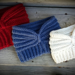 May include: Three crocheted headbands in red, blue, and white. Each headband has a bow detail.