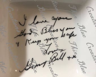 May include: White ceramic dish with a handwritten message that reads "I love you so. Bless you & keep you safe.  Tony Bull + x". The message is written in black ink.
