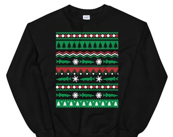 May include: Black sweatshirt with a Christmas-themed pattern featuring green and red fish, snowflakes, and Christmas trees.