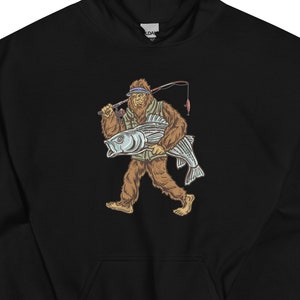 May include: Black hooded sweatshirt with a graphic print of a Bigfoot holding a fish and a fishing rod.
