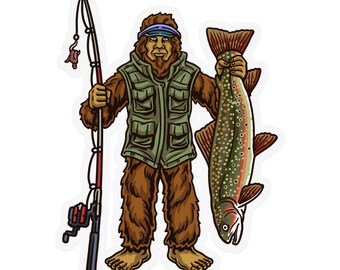 Może przedstawiać: Naklejka przedstawiająca postać z kreskówki Bigfoot, ubraną w zieloną kamizelkę i daszek, trzymającą wędkę i dużą rybę. Bigfoot jest brązowy i owłosiony. Ryba jest nakrapiana na czerwono i zielono.