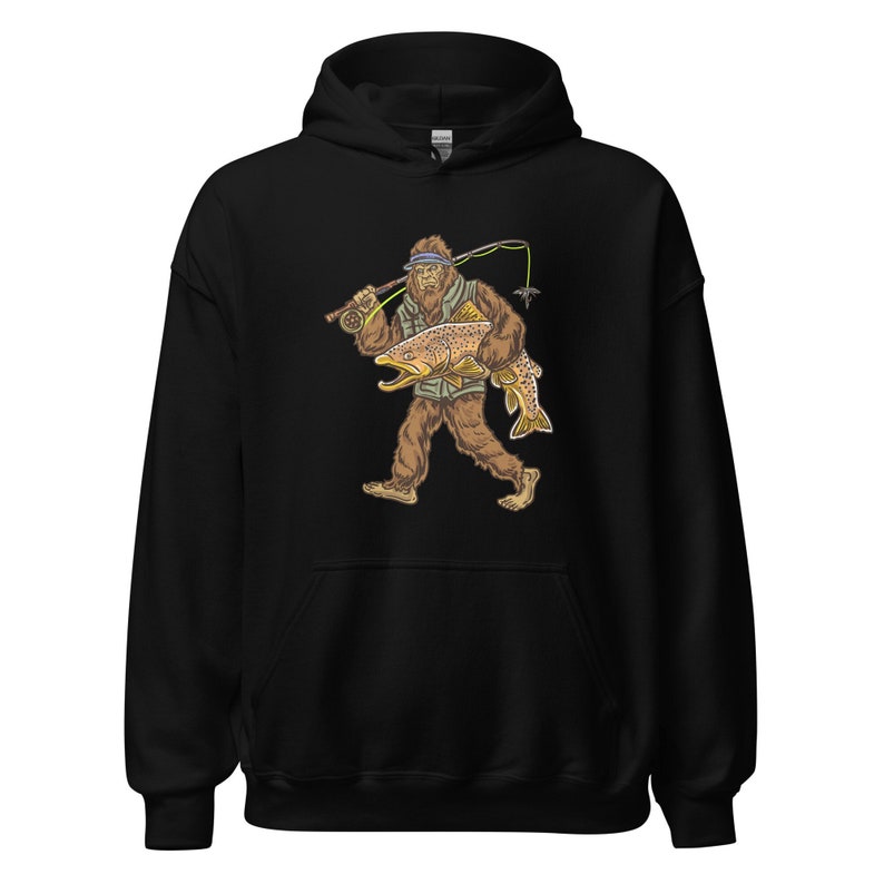 May include: Black hooded sweatshirt with a graphic of a Bigfoot holding a large trout. The Bigfoot is wearing a hat and holding a fishing rod.