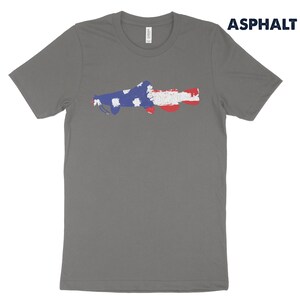 May include: A gray t-shirt with a distressed American flag design of a fish. The text "ASPHALT" is in the upper right corner of the image.