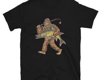 May include: Black t-shirt with a graphic of a Bigfoot holding a fish. The Bigfoot is wearing a hat and holding a fishing rod.