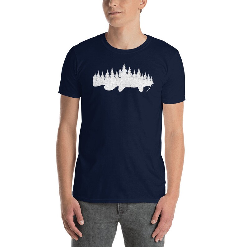May include: A navy blue t-shirt with a white silhouette of a fish with a forest inside of it.