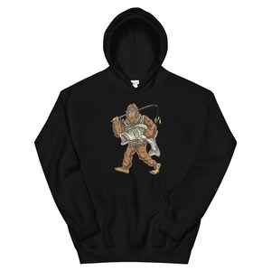 May include: Black hooded sweatshirt with a graphic of a Bigfoot holding a fish and a fishing rod. The Bigfoot is wearing a blue bandana and a green vest.