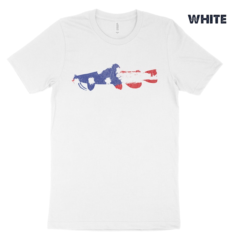 May include: White t-shirt with a distressed American flag design in the shape of a fish.